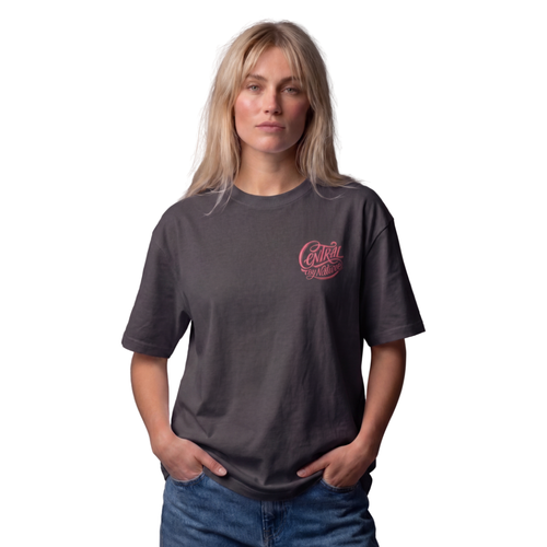 Woman wearing the graphite Course America tee with the pink Central by Nature script on the chest