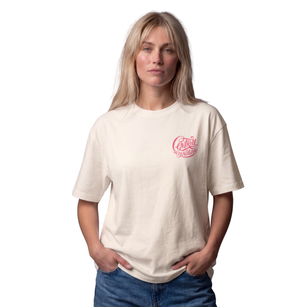 Woman wearing the ivory Course America tee with the pink Central by Nature script on the chest