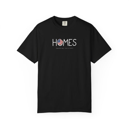 Black Course America tee, flat front view, printed HOMES in white with a flag filled O, above the words pending revision