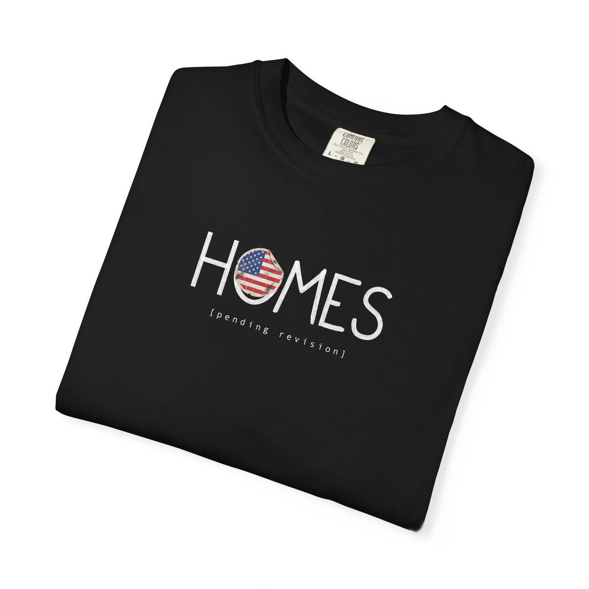 Black Course America tee, folded, showing HOMES in white with a flag filled O, above the words pending revision